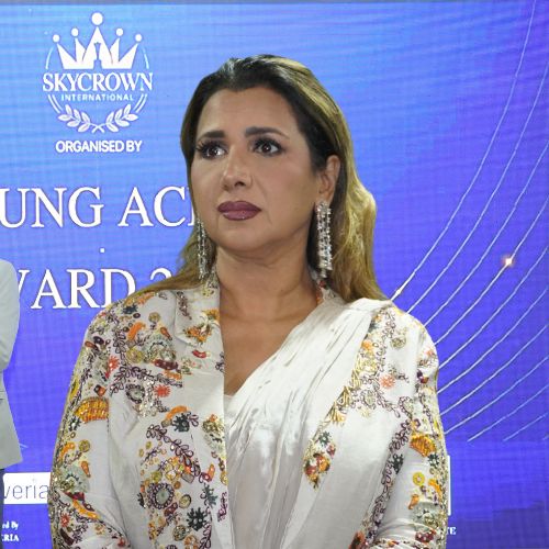 Woman in elegant attire, serious expression